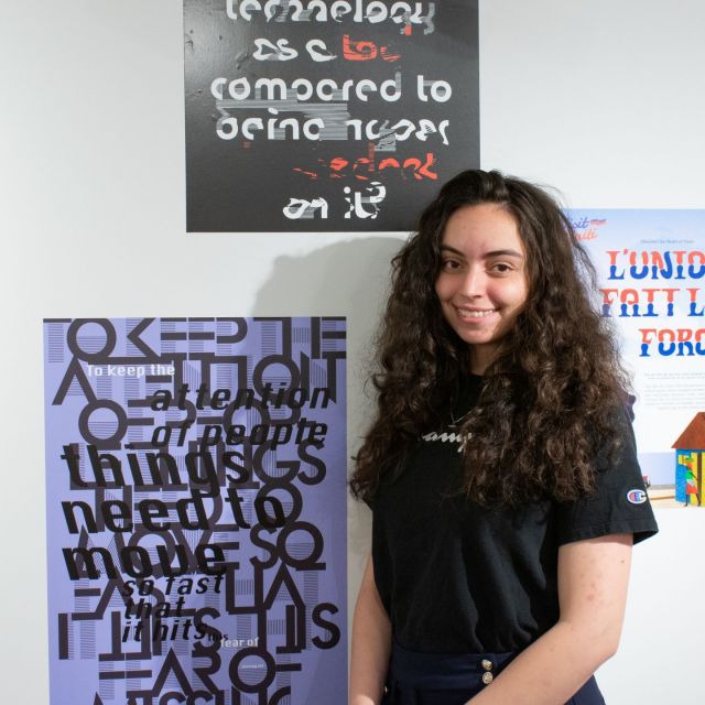 Happy Feature Friday! This week we have the pleasure of featuring Sam Niedbalski! Sam is a Graphic Design major who is graduating this spring. Before their current major, they were studying Cinematography in high school and at Rowan University. They studied cinematography for 8 years before switching to Graphic Design here at Rutgers–Camden. Growing up, she says that her grandmother really wanted her to go to art school but like many people, her goal was to find a job that she liked and that was stable enough to give her a comfortable life. When she learned how graphic design could do that for her and allow her to use her creativity, then it was an easy choice. Prof. Allan Espiritu and Prof. Alejandro Loureiro Lorenzo are two professors who have inspired Sam a lot during her time here on campus. Some of her biggest accomplishments thus far have been bringing back The Gleaner, which is a campus online newspaper, and helping to design Tenure Packages for teachers. Sam’s work shows her attention to detail and her goal is to bring a sense of communication and community with each piece she makes.
📸 : Abby Vanono